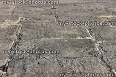 Stock image of grey flagstone paving slabs forming garden patio, hardscaping