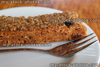 Stock image of homemade flapjack biscuit made with oats, raisins, golden syrup
