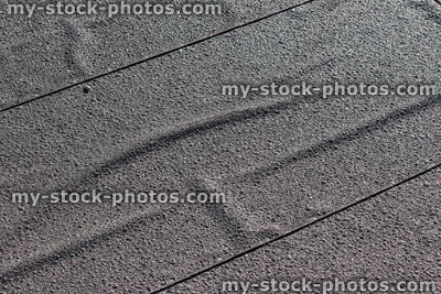 Stock image of rows of felt on shed roof, tacked together