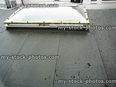 Stock image of wet felt / asphalt flat roof, bowed skylights / rooflight windows