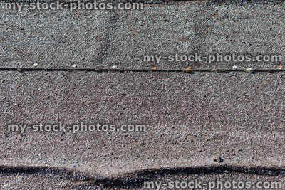 Stock image of mineral felt covering shed roof, creased and tacked