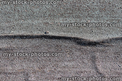 Stock image of creased felt shed roof, tar and mineral surfaced roofing