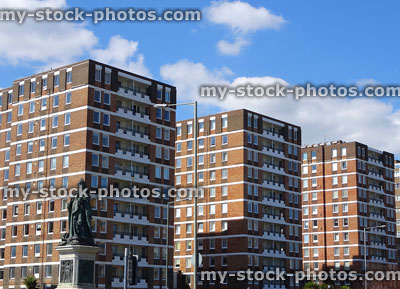 Stock image of tall blocks of red brick flats / dated 1970s apartment blocks