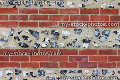 Stock image of traditional red brick and flintstone wall / striped flint stone wall