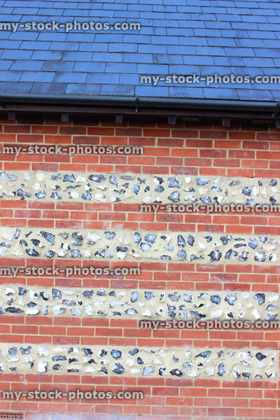 Stock image of traditional red brick and flintstone wall / striped flint stone wall