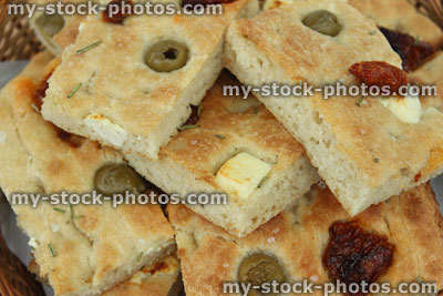 Stock image of focaccia bread toppings, green olives, sun dried tomatoes, feta cheese