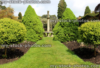 Stock image of formal garden with topiary trees, shrubs and sundial