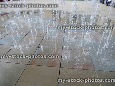 Stock image of pavement fountains, jets of water through paving slabs