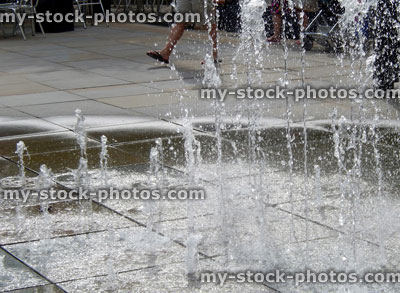 Stock image of pavement fountains, jets of water through paving slabs