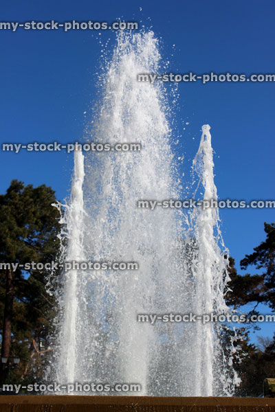 Stock image of large outdoor fountain against sunny blue sky (close up)