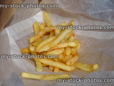 Stock image of greasy golden French fries from takeaway chip shop