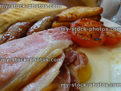 Stock image of traditional English breakfast / fry up, fried egg, greasy bacon