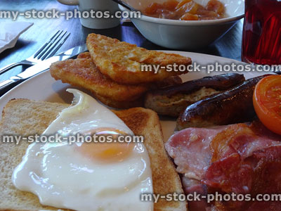 Stock image of fried egg on toast, English fry up, bacon, sausages