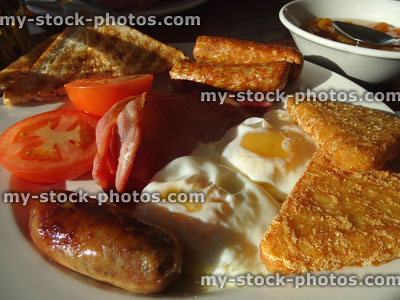Stock image of filling English fried breakfast, sausages, bacon, fried-eggs, toast