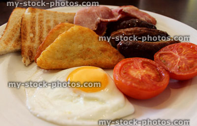 Stock image of full English breakfast, with sausage, bacon and egg