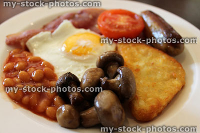 Stock image of fried breakfast, with sausage, bacon and baked beans