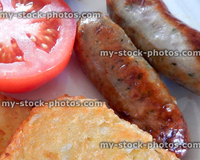 Stock image of fried breakfast / fry up with sausages, hash brown, tomato