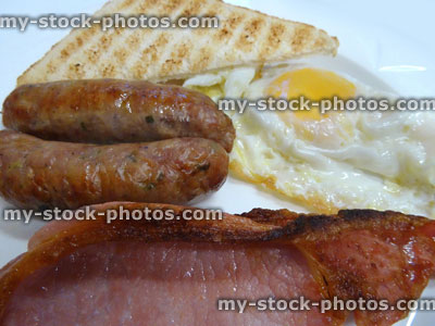 Stock image of fried breakfast, sausages, bacon, fried egg, white toast