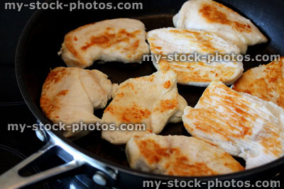 Stock image of fried chicken in non stick frying pan, fried chicken breasts
