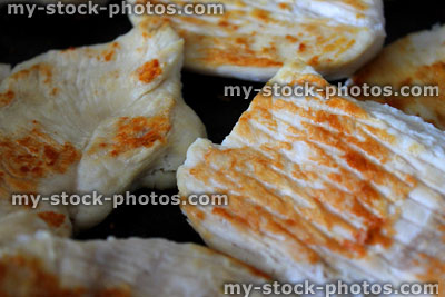 Stock image of fried chicken in non stick frying pan, fried chicken breasts