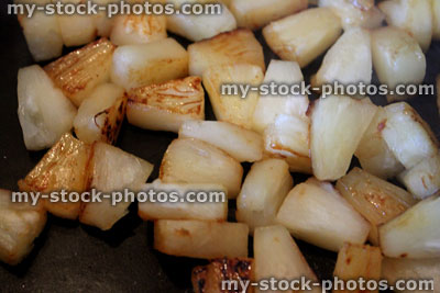 Stock image of fried pieces of pineapple / frying pineapple chunks / frying pan