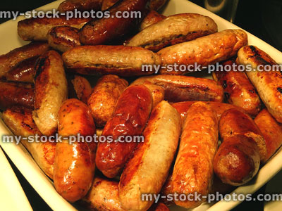 Stock image of dish of pork sausages at fried breakfast buffet