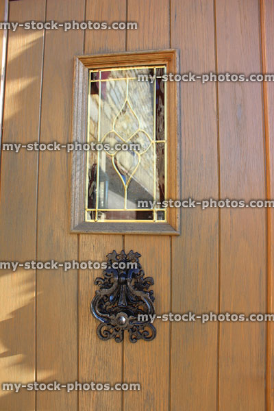 Stock image of wooden front door / back door, stained glass window, door knocker