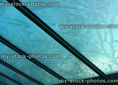Stock image of frost pattern on a glass conservatory roof blurred sun