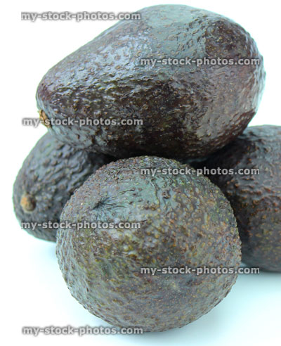 Stock image of dark green, ripe avocados, isolated on white background