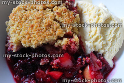 Stock image of summer fruit and apple crumble with ice cream
