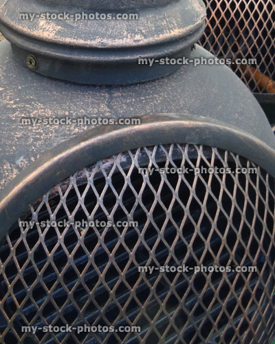 Stock image of metal and clay chiminea / chimney fireplace door close up
