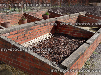 Stock image of brick cold frame in vegetable allotment garden, hardening off plants