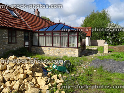 Stock image of barn conversion square conservatory with glass pyramid roof
