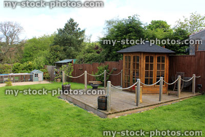 Stock image of wooden gazebo / summer house on decking timber in ornamental garden