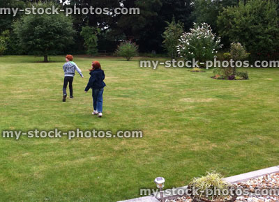 Stock image of children running on Lawn