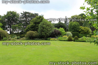 Stock image of large garden lawn turf like bowling green, shrubs, flowers, trees