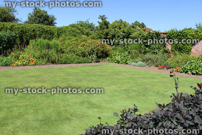 Stock image of green garden lawn, freshly mown, fine grass / turf, brick pathway, flowers shrubs