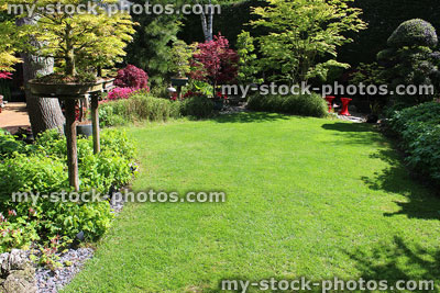 Stock image of irregular shaped green lawn with fine mown grass