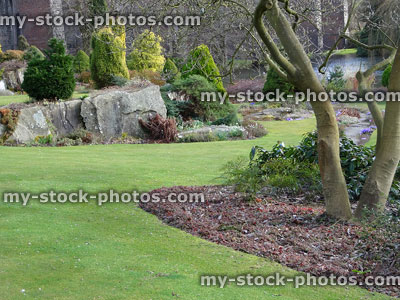 Stock image of landscaped garden with edged lawn / short grass, rockery rocks