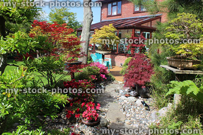 Stock image of stepping stones and pebble pathway, Japanese garden with conservatory