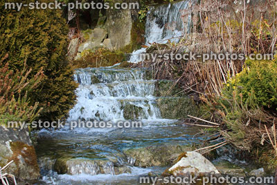 Stock image of natural looking rockery waterfall in a landscaped rock garden