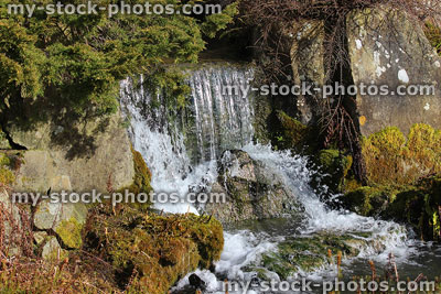 Stock image of natural waterfall stream in landscaped rockery rock garden