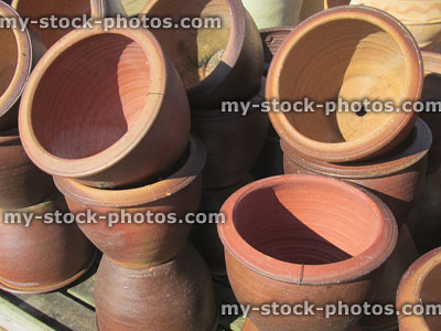 Stock image of stack of round, stone / terracotta garden pots