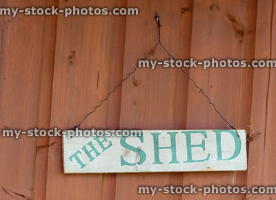 Stock image of homemade stenciled sign on wooden garden shed
