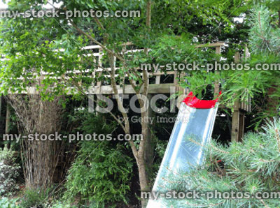 Stock image of wooden tree top walkway / treehouse and slide