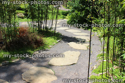 Stock image of Japanese garden natural stepping stones with black bamboo