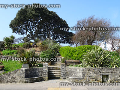 Stock image of public raised garden with steps, retaining stone wall