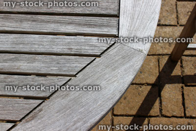 Stock image of weathered wooden garden table top, teak furniture