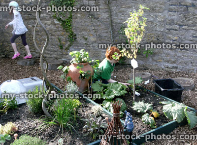 Stock image of children working on a raised vegetable garden