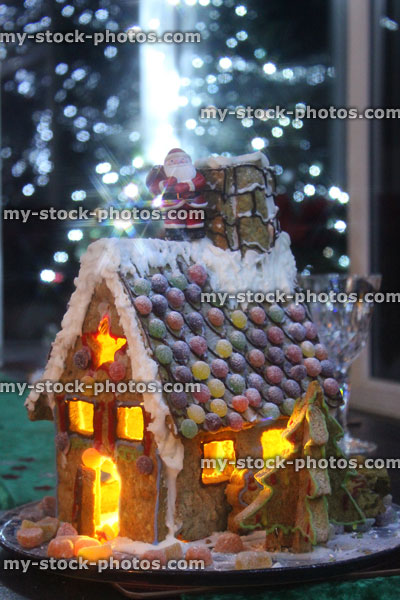 Stock image of gingerbread house at night with Christmas Santa and fairy lights